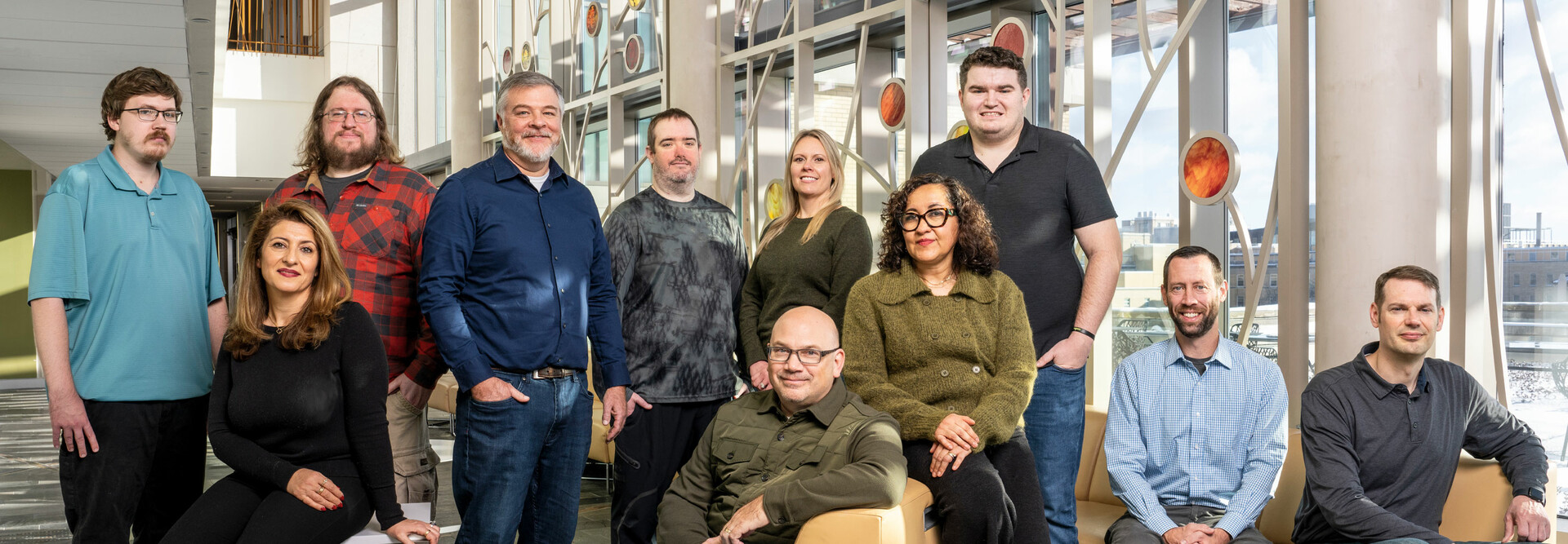 A team of IT employees at the Universities of Wisconsin pose for a photo.