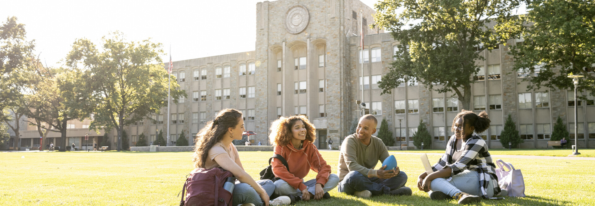 Students sitting on the campus grounds