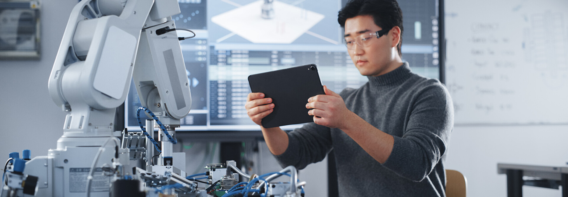 Student Holding Tablet and Controlling Robot Hand Moving at Different Ways At University Class