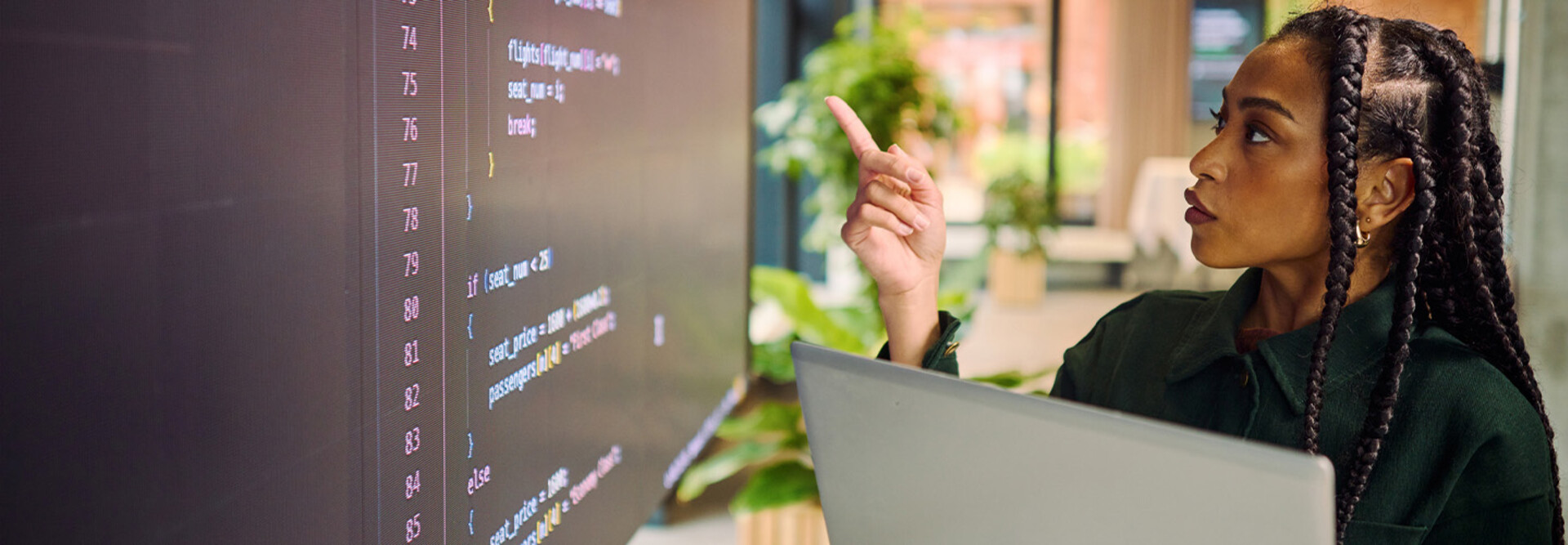 Person analyzing code on laptop