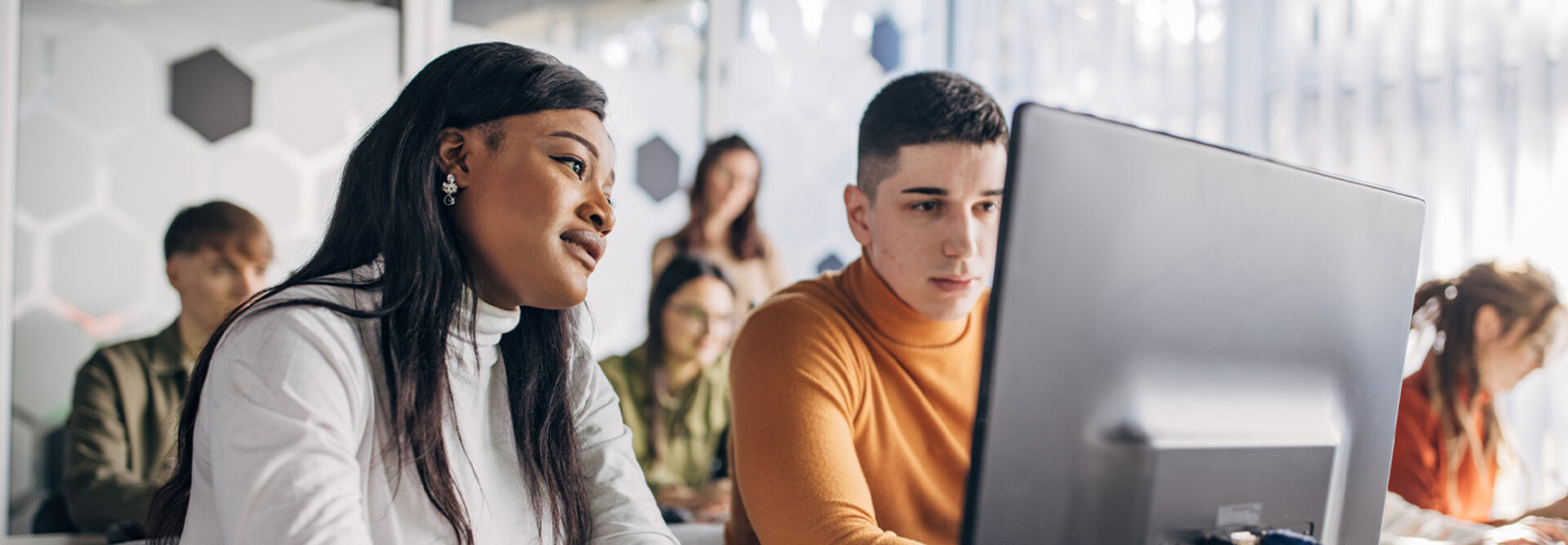 Students looking at computer