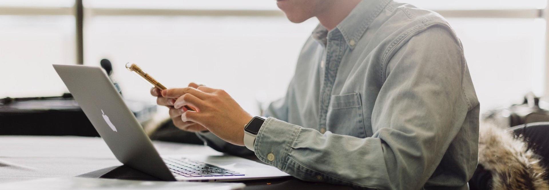 college student with laptop and phone