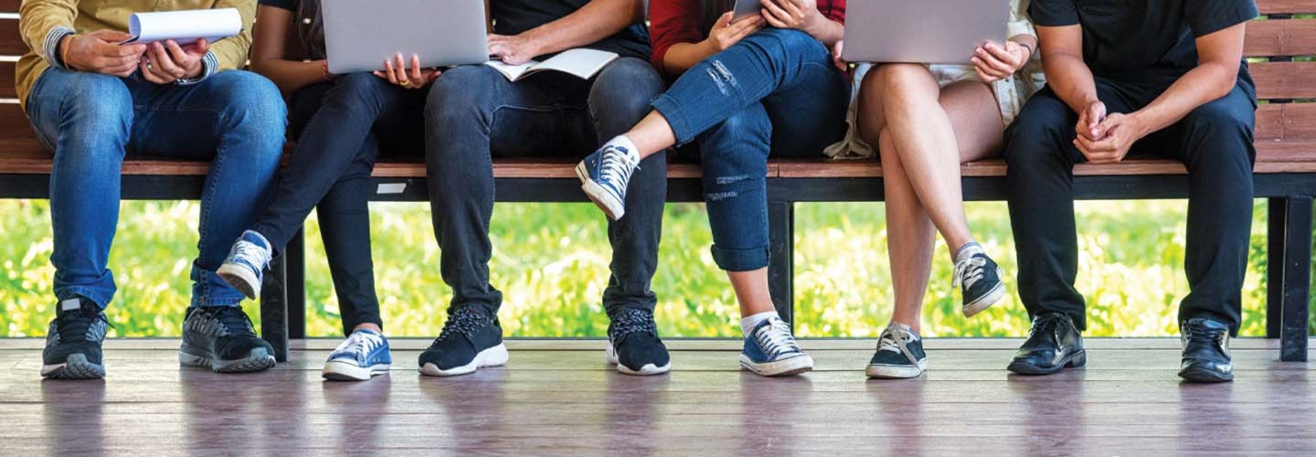 A group of college students seated on a bench