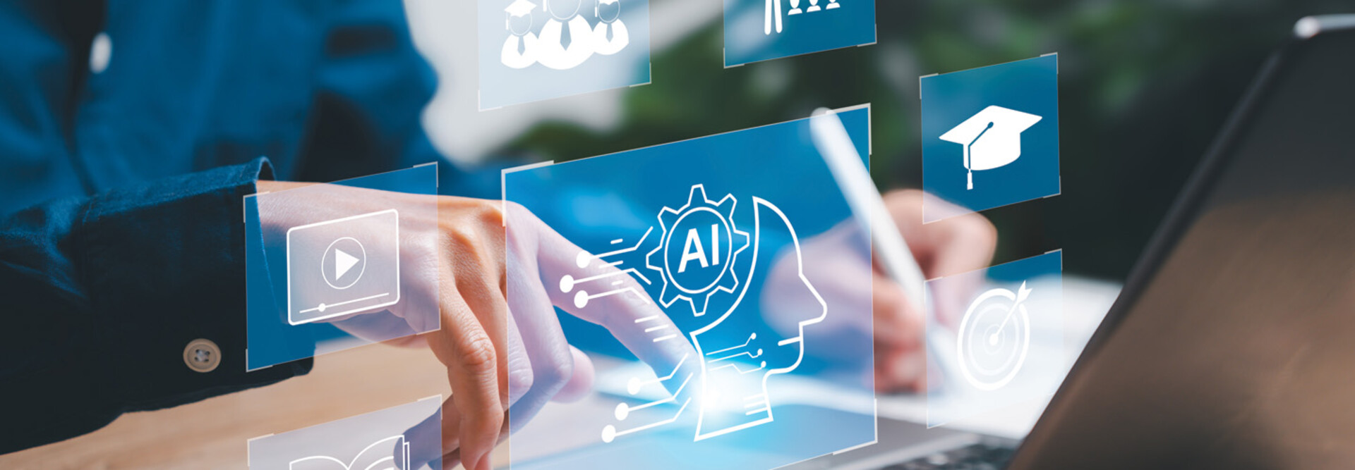 Some tech-looking icons superimposed over a person's hands on a laptop