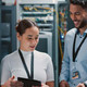 two colleagues working together in a server room