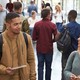 College students walk and talk in a crowded modern building