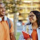 Two college students chat on an outdoor walk