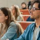 Students in a lecture hall listen intently