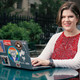 Patricia Clay uses her desktop at an outdoor table