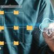 Visualization of a man using a touchscreen to move files into the cloud