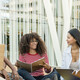 A group of students chat outside on a college campus