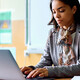 Teacher working on her laptop in the classroom