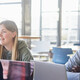 Diverse group of students smiling and studying at computers