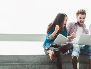 College Students excited about laptop