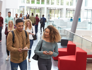 Students walking with mobile tech