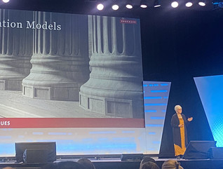 Susan Grajek standing onstage presenting