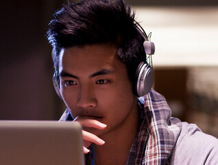 Student working on laptop in library