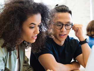 College students working together in class