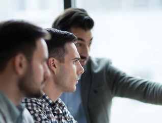 A group of coworkers reviewing a desktop