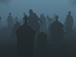 Silhouetted zombies rise from a foggy graveyard