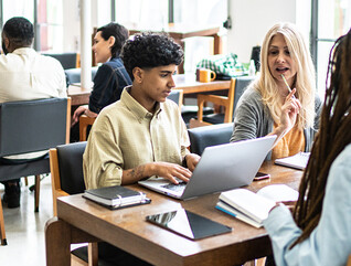 Students working at tables together