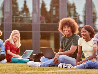 Students using device on quad
