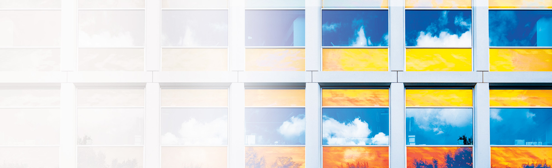 A building with reflections of clouds in its windows