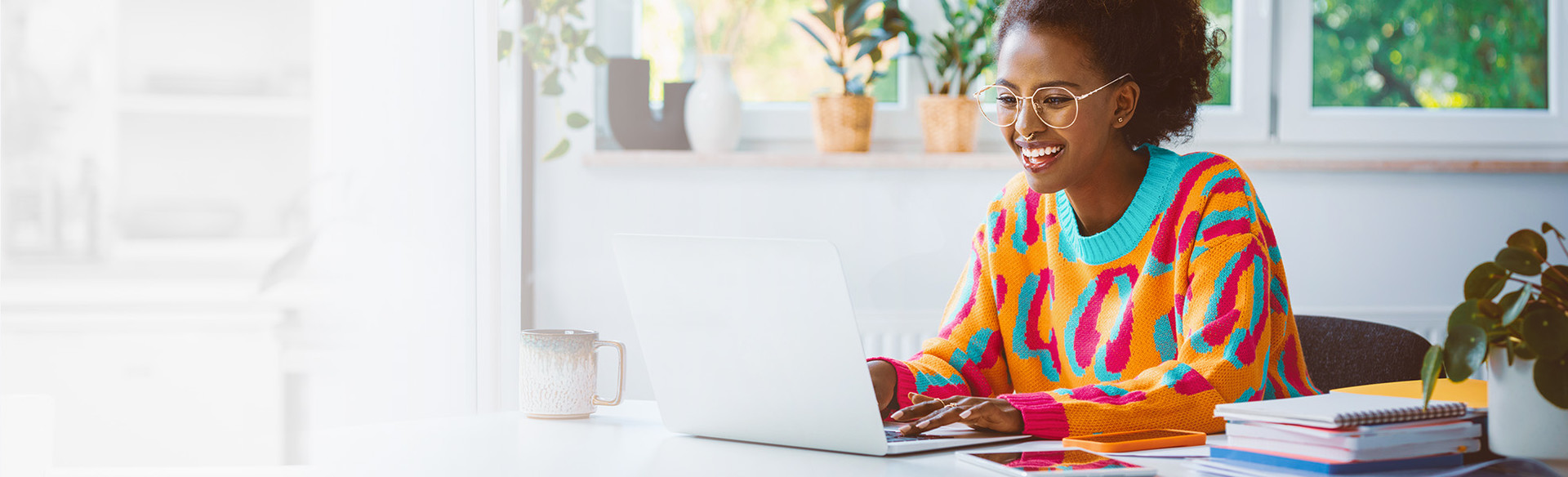 A happy woman works on her laptop