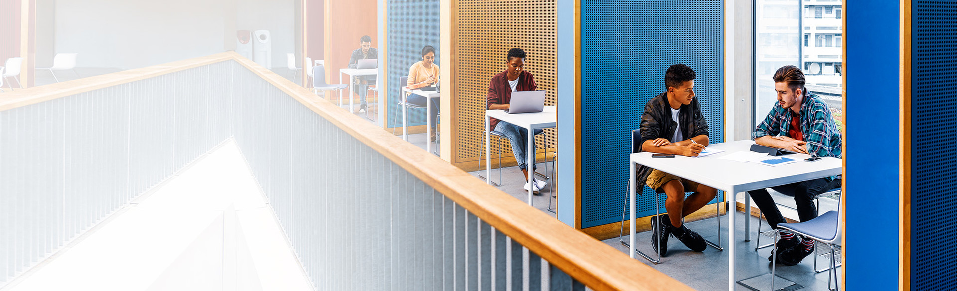 People work at desks inside a smart building