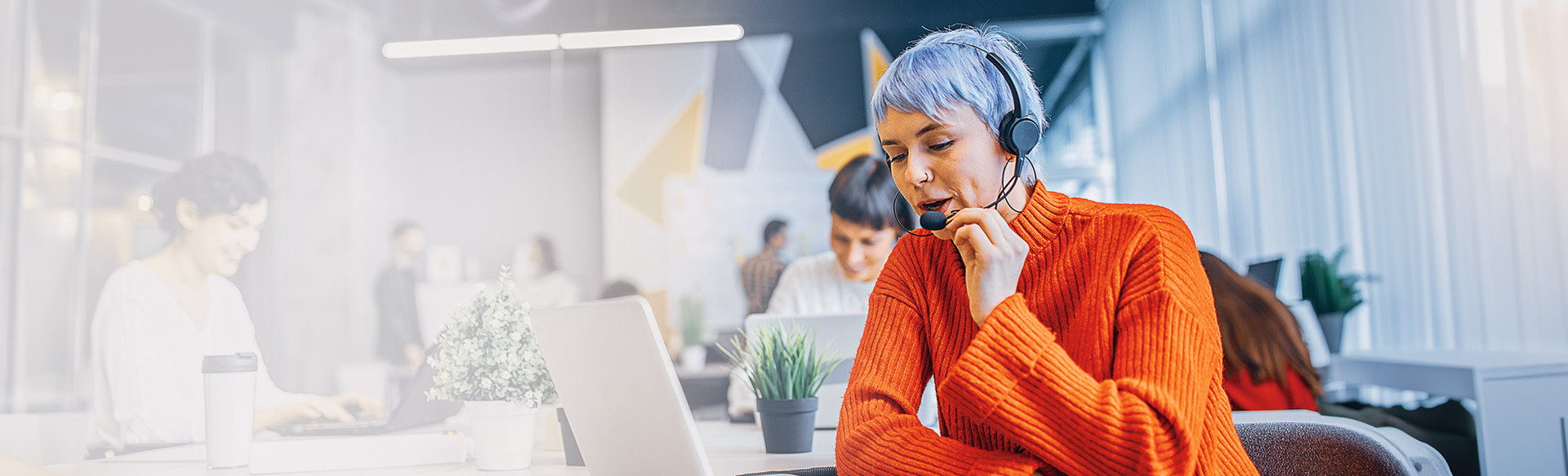 A woman talks on a headset