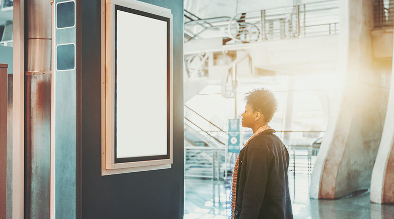 girl looking at digital sign