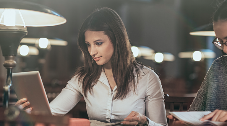 Girl on tablet in the library