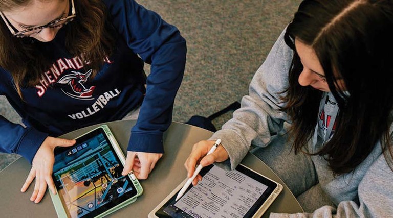 Shenandoah University students use technology at a table