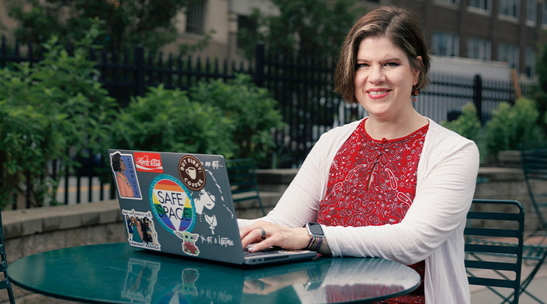 Patricia Clay uses her desktop at an outdoor table