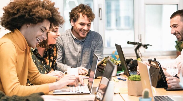 Students work together around a table