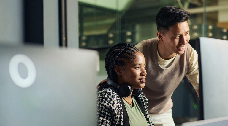 Professor helping student in computer lab