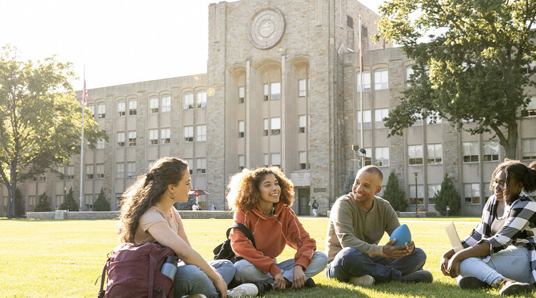 Students sitting on the campus grounds