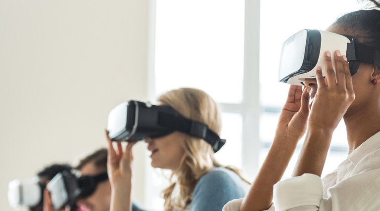 College students wearing VR headsets