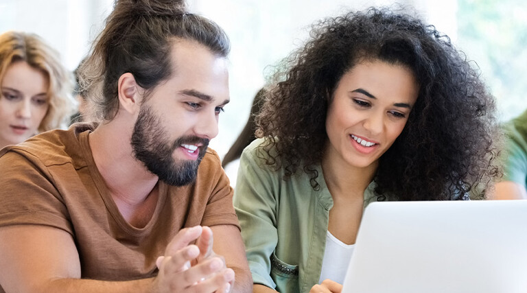 Students collaborating with tech