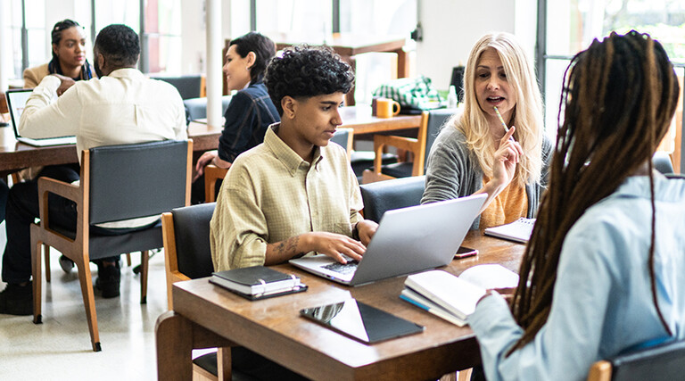 Students working at tables together