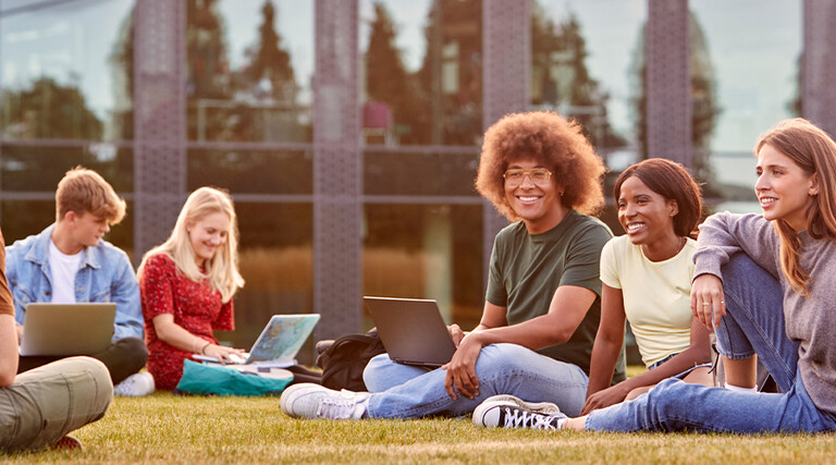 Students using device on quad