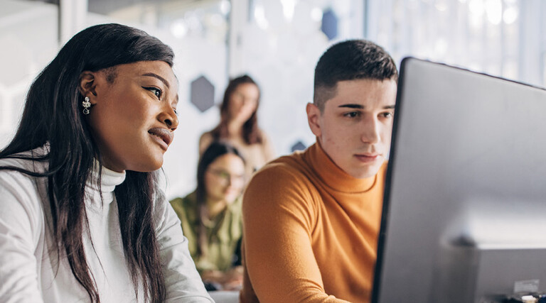 Students looking at computer