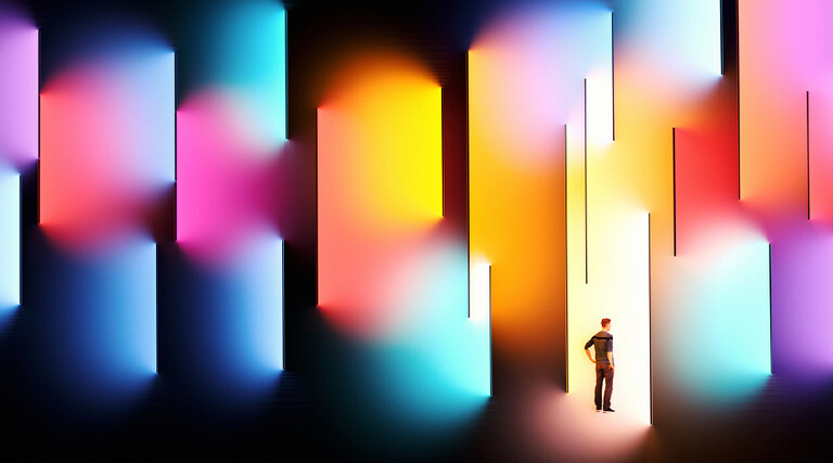 Illustration of person surrounded by multicolor spotlight 