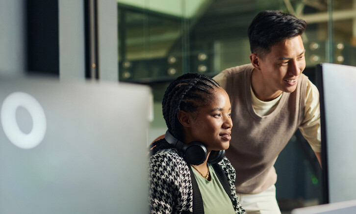 Professor helping student in computer lab