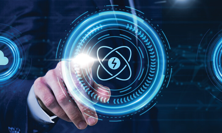 Person pressing illustrated atom