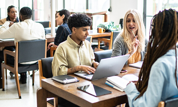 Students working at tables together