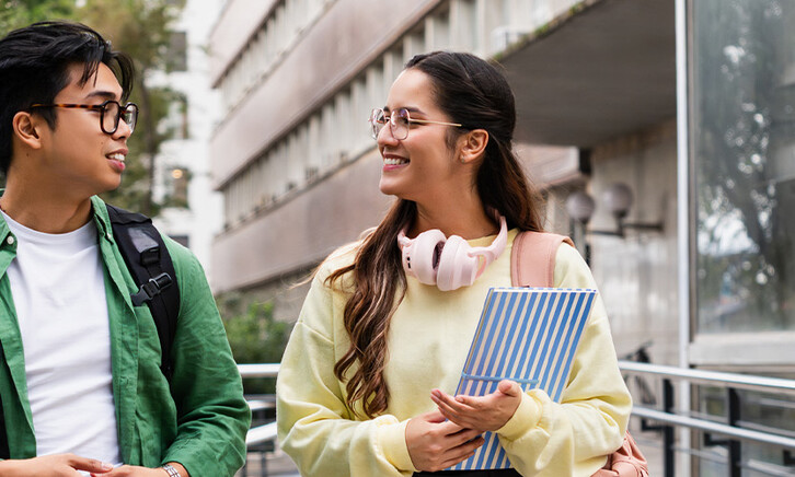 Student friends walking with books