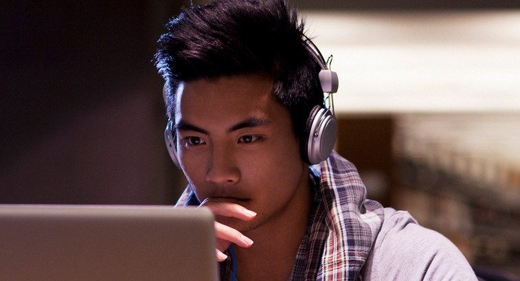 Student working on laptop in library