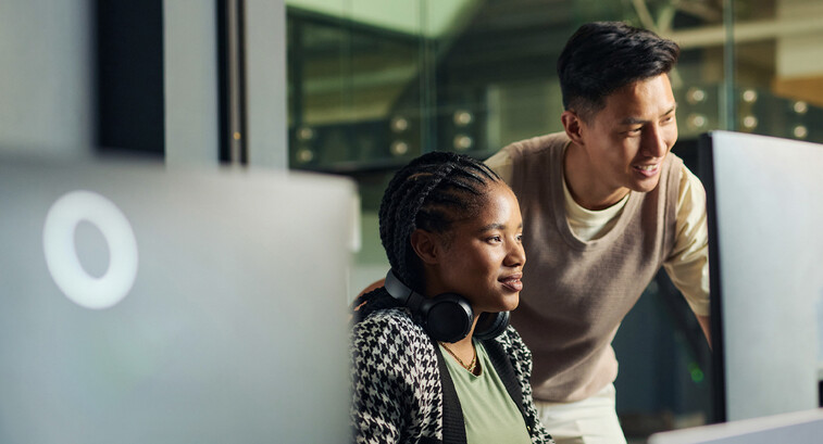 Professor helping student in computer lab