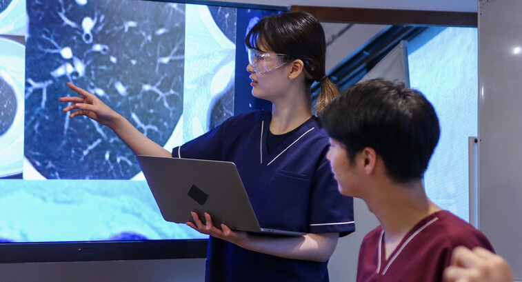 Health care professionals looking at medical x-rays